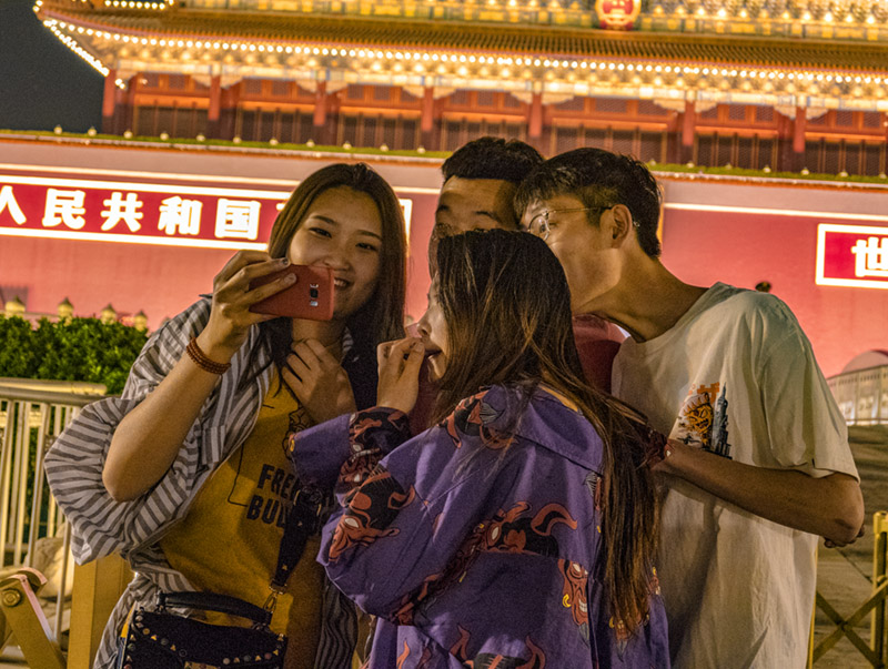 Chinese teenagers taking a selfie at Tiananmen  Square in Beijing, China
